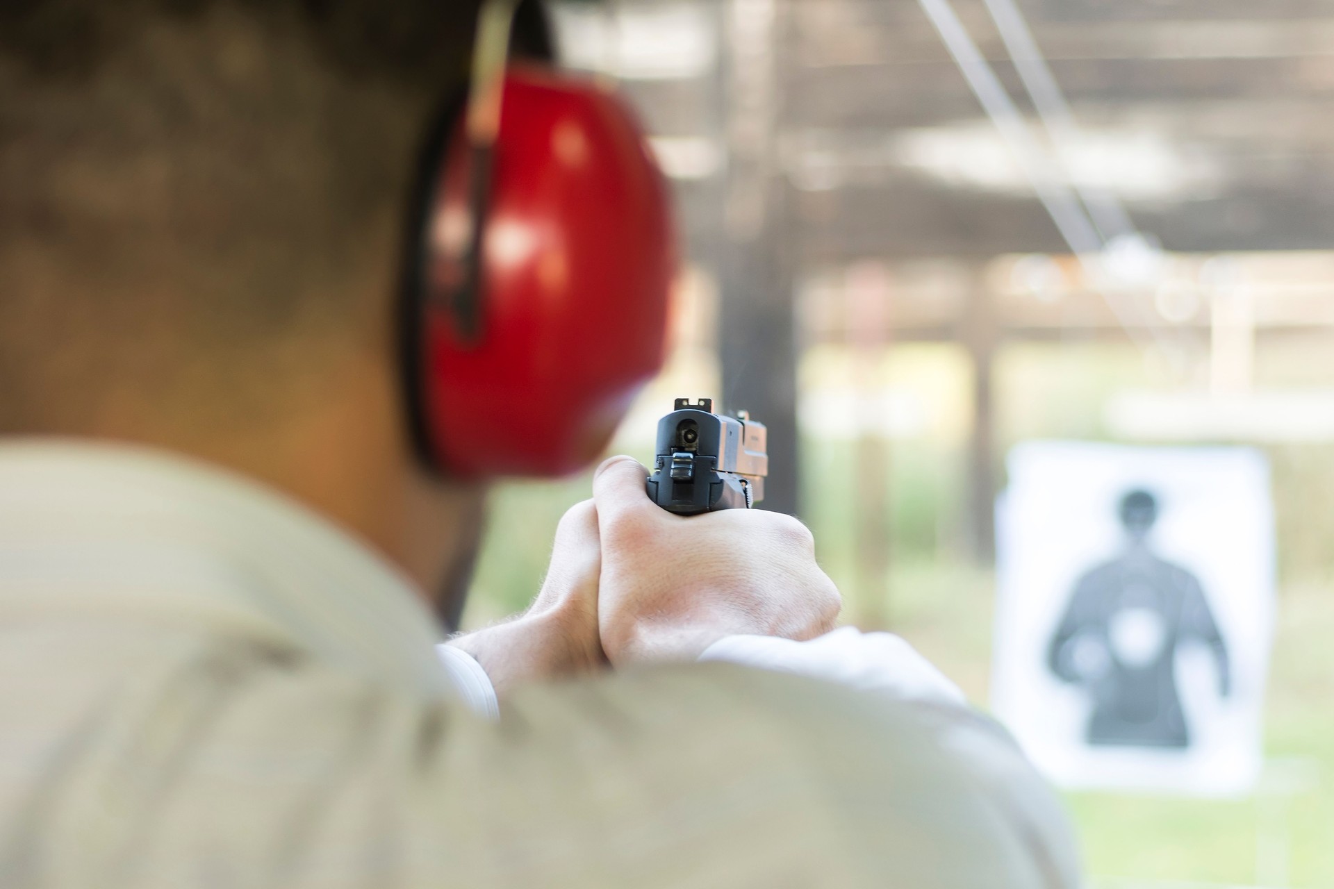 Shooting with Gun at Target in Shooting Range